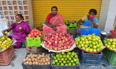 Roadside vendors selling fruits wait for customers, as coronavirus cases surge across the country, in Bengaluru. (PTI)